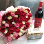 Red and white roses with wine and chocolate
